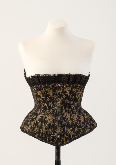 Black woven silk boned corset, with tiny blue and pink flowers, 1890s by Unbekannt Unbekannt